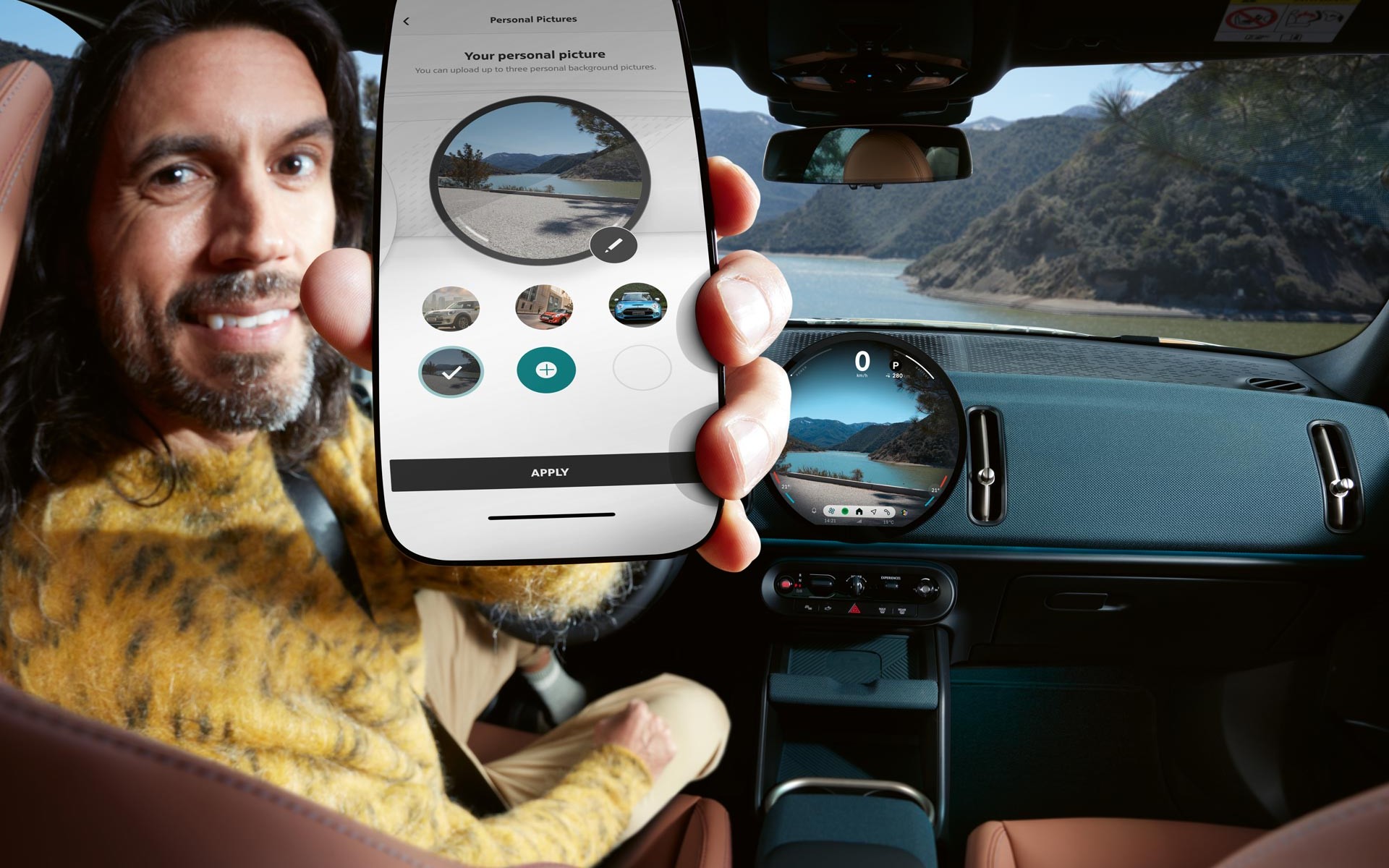 Man in car displaying The MINI App on his mobile